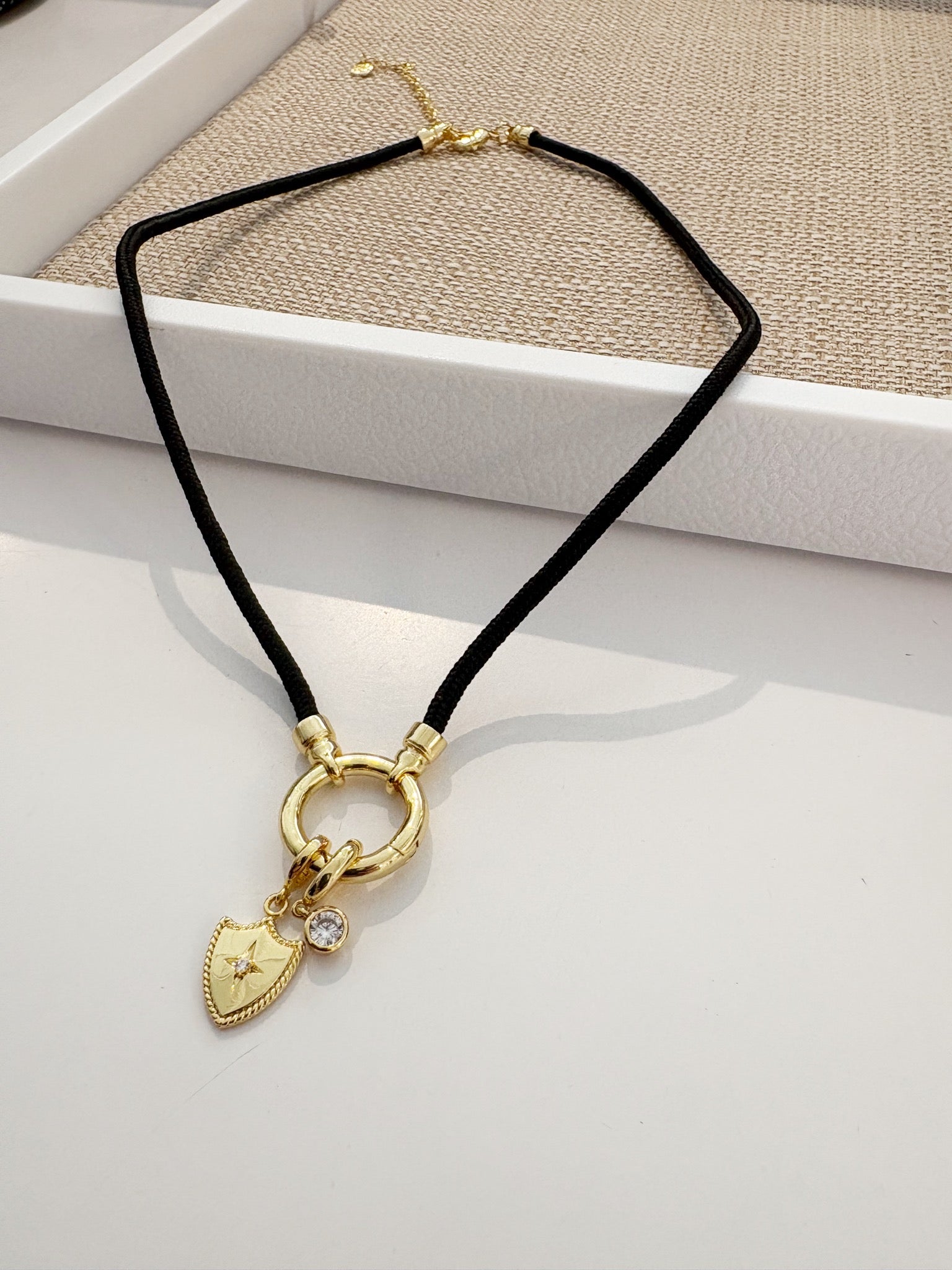 Effie Crystal and Shield Charms on Kai Corded Necklace {Gold/Black}
